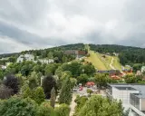 Widok na Krynicę-Zdrój z trasą narciarską i zabudowaniami. Sprawdź sanatorium krynica zdrój cennik.