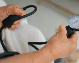 Dłonie mierzą ciśnienie, które wynosi 99 na 66.